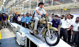 Siddhartha Lal rolls the first production motorcycle off the assembly line. 